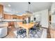 Bright kitchen and dining area with hardwood floors, island, stainless appliances, and pendant lighting at 10123 Barrands Ln, Charlotte, NC 28278