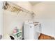 Well-lit laundry room includes new washer and dryer units, wire rack shelving and wooden-look flooring at 10123 Barrands Ln, Charlotte, NC 28278