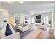 Spacious living room filled with natural light, neutral furniture, and a cozy fireplace at 10123 Barrands Ln, Charlotte, NC 28278