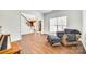 Comfortable living room featuring hardwood floors, a large window, and a cozy armchair with ottoman at 10123 Barrands Ln, Charlotte, NC 28278