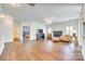 Spacious living room featuring hardwood floors, fireplace, ceiling fan, and ample natural light at 10123 Barrands Ln, Charlotte, NC 28278