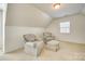 Cozy bonus room with two cushioned armchairs and matching ottoman near window at 10123 Barrands Ln, Charlotte, NC 28278