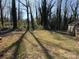 View of the backyard area with grass and shadow patterns at 1027 Morningside Park Dr, Gastonia, NC 28054