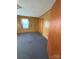 Bedroom with wood paneled walls and neutral carpeting, door to the right at 1027 Morningside Park Dr, Gastonia, NC 28054