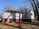 A view of the side of a home that has white siding and a red painted foundation at 1027 Morningside Park Dr, Gastonia, NC 28054