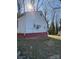 Side view of a home featuring white siding, painted foundation and AC unit at 1027 Morningside Park Dr, Gastonia, NC 28054