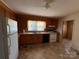 Well-lit kitchen with wood cabinets, appliances, and a practical layout at 1027 Morningside Park Dr, Gastonia, NC 28054