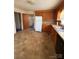 Kitchen with wood cabinets and laminate countertops offers renovation potential at 1027 Morningside Park Dr, Gastonia, NC 28054