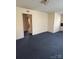 Spacious living room featuring blue carpet and doorway leading to another room at 1027 Morningside Park Dr, Gastonia, NC 28054