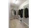 Walk-in closet with wire shelving filled with clothing and assorted shoes on the carpeted floor at 12207 Jessica Pl, Charlotte, NC 28269