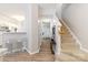 Bright entryway showcasing wood floors, stairs, and access to kitchen, creating an inviting and seamless transition at 12207 Jessica Pl, Charlotte, NC 28269