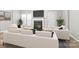 Modern living room with a fireplace, hardwood floors, and stylish white furniture, designed for relaxation and entertainment at 12207 Jessica Pl, Charlotte, NC 28269