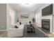 Bright living room featuring a fireplace, TV, large windows, hardwood floors, and modern furnishings, creating a relaxing atmosphere at 12207 Jessica Pl, Charlotte, NC 28269