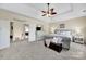 Spacious bedroom features a decorative ceiling fan, ensuite access, and a plush bed at 1569 Benjamen Latrobe Cir, Fort Mill, SC 29708
