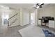 Bright bonus room features stairs, ceiling fan, carpeted floors and a functional desk space for work or study at 1569 Benjamen Latrobe Cir, Fort Mill, SC 29708