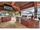 Spacious cabana interior featuring a built-in bar, stainless steel grill, wooden cabinets and convenient amenities at 1569 Benjamen Latrobe Cir, Fort Mill, SC 29708