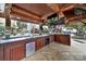 Well-equipped cabana interior with mini-fridges, tile countertops, a sink and outdoor entertainment possibilities at 1569 Benjamen Latrobe Cir, Fort Mill, SC 29708