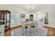 Elegant dining room with hardwood floors, a vintage hutch, and large windows providing natural light at 1569 Benjamen Latrobe Cir, Fort Mill, SC 29708