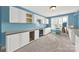 Hobby space with light blue walls, carpeted floors, and multiple cabinets and countertop space at 1569 Benjamen Latrobe Cir, Fort Mill, SC 29708