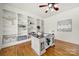Well-appointed home office featuring custom bookshelves, hardwood floors, and ample natural light at 1569 Benjamen Latrobe Cir, Fort Mill, SC 29708