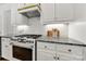 Kitchen with white cabinetry, granite countertops, subway tile backsplash, and stainless steel range at 1569 Benjamen Latrobe Cir, Fort Mill, SC 29708