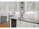 Bright kitchen features elegant countertops, white cabinets and a built-in wine cooler at 1569 Benjamen Latrobe Cir, Fort Mill, SC 29708