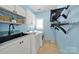 Well-lit laundry room with blue walls, sleek cabinetry, a sink, and modern appliances at 1569 Benjamen Latrobe Cir, Fort Mill, SC 29708