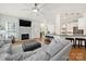Cozy living room with fireplace, hardwood floors, and an open layout to the kitchen at 1569 Benjamen Latrobe Cir, Fort Mill, SC 29708