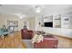Bright living room featuring built-in cabinets, hardwood floors, and leather chairs at 1569 Benjamen Latrobe Cir, Fort Mill, SC 29708