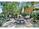 Charming outdoor space with a stone fireplace, dining set, and landscaped garden for relaxing and entertaining at 1569 Benjamen Latrobe Cir, Fort Mill, SC 29708