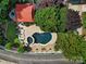 Aerial view of pool with surrounding patio, gazebo and lush landscaping creating a private backyard oasis at 1569 Benjamen Latrobe Cir, Fort Mill, SC 29708
