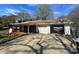 Charming single-story home featuring a brick facade, attached garage, and covered porch at 1632 Browns Ave, Charlotte, NC 28208