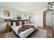 Bedroom featuring bed, accent pillows, side tables, and hardwood flooring at 1749 Archdale Dr, Charlotte, NC 28210