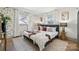 Bedroom featuring a bed, accent pillows, two windows, and patterned wallpaper at 1749 Archdale Dr, Charlotte, NC 28210