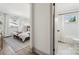 Bedroom with stylish wallpaper, windows, and doorway into bathroom at 1749 Archdale Dr, Charlotte, NC 28210