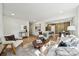 Open-concept living room flowing into the modern kitchen and dining area, hardwood floors, and a comfortable seating area at 1749 Archdale Dr, Charlotte, NC 28210