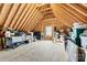 Unfinished attic space featuring exposed rafters and beams, with a window for natural light at 188 Winding Forest Dr, Troutman, NC 28166