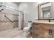 Bathroom featuring a walk-in shower with designer tile, a wood vanity with granite counters at 188 Winding Forest Dr, Troutman, NC 28166