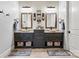 Double vanity bathroom featuring granite countertops, vessel sinks, and stylish framed mirrors at 188 Winding Forest Dr, Troutman, NC 28166