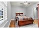 Bedroom with a cozy bed, neutral colors, side table, and ample natural light at 188 Winding Forest Dr, Troutman, NC 28166