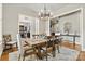 The dining room features a wooden table and chairs with a chandelier above a gray rug at 188 Winding Forest Dr, Troutman, NC 28166