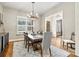 Formal dining room featuring natural light and an elegant chandelier, adjoining living spaces at 188 Winding Forest Dr, Troutman, NC 28166