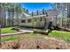 Charming home exterior with stone accents, a landscaped yard, and a fire pit at 188 Winding Forest Dr, Troutman, NC 28166