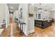 Hallway view into kitchen with large island, modern fixtures, and hardwood floors at 188 Winding Forest Dr, Troutman, NC 28166