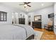 Comfortable main bedroom with hardwood floors, dresser and a hallway leading to the kitchen at 188 Winding Forest Dr, Troutman, NC 28166