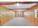 Finished basement with wood paneled walls, carpet flooring, and functional layout at 2300 Highlawn Dr, Charlotte, NC 28212