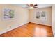 Cozy bedroom with hardwood floors, neutral walls, and dual windows providing natural light at 2300 Highlawn Dr, Charlotte, NC 28212