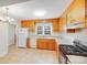 Bright kitchen featuring wood cabinets, tile flooring, and a window above the sink, allowing for ample natural light at 2300 Highlawn Dr, Charlotte, NC 28212