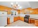 Well-lit kitchen with wooden cabinets, modern appliances, and ample countertop space, ideal for cooking at 2300 Highlawn Dr, Charlotte, NC 28212