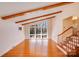 Bright living room with hardwood floors, exposed beams, and lots of light coming in from large windows at 2300 Highlawn Dr, Charlotte, NC 28212